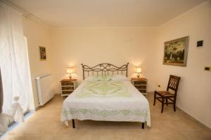 a bedroom with a large bed and two chairs at Antica Dimora B&B Canosa in Canosa di Puglia