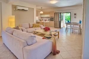 a living room with a couch and a table at Villa Kiki Paxos Ozias in Gaios