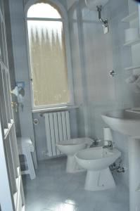 a white bathroom with two toilets and a sink at Aldebaran B&B in Cava deʼ Tirreni +39 photos