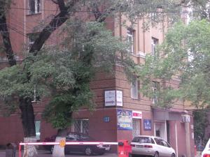 a building with cars parked in front of it at D'Rami in Almaty