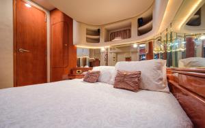 a bedroom with a large white bed with pillows at Luxury Yacht Hotel in Gibraltar