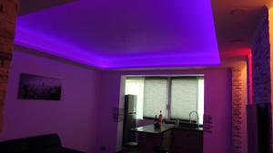 a room with a purple ceiling and a kitchen at Catalans in Marseille
