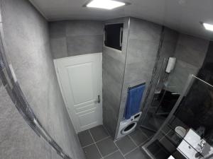 a bathroom with a shower and a white door at Catalans in Marseille