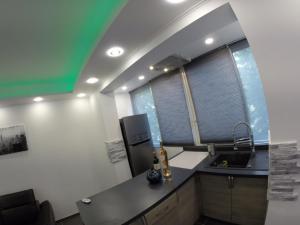 a kitchen with a counter and a sink and two windows at Catalans in Marseille