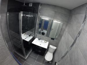 a bathroom with two sinks and a large mirror at Catalans in Marseille