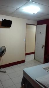 Pokój z pokojem z drzwiami i białą podłogą w obiekcie Hostal Don Frank w mieście San Carlos