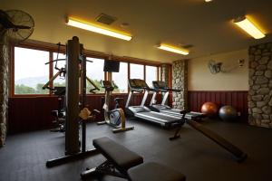 a gym with several treadmills and machines in a room at Fable Terrace Downs Resort by MGallery in Windwhistle