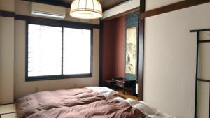 เตียงในห้องที่ Guest House Kuranomachi ゲストハウス蔵の街