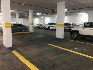 a parking garage filled with lots of parked cars at Arjaan Altakhassusi Hotel Suites in Riyadh
