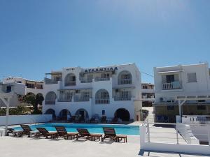 a large white building with a pool in front of it at Atlantida Hotel in Koufonisia
