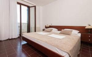 Postel nebo postele na pokoji v ubytování Hotel Zenit Neum