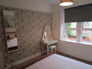 a bedroom with a mirror and a bed in it at Westend Glasgow Apartment in Glasgow