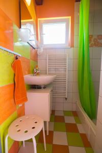 a colorful bathroom with a sink and a stool at Domceky Holiday in Liptovský Trnovec