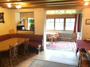 a dining room with a table and chairs and a table at Austrian Alps - Haus Kienreich in Altenmarkt im Pongau