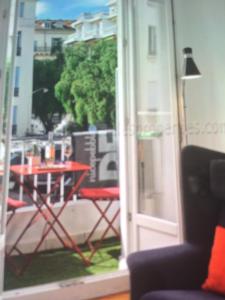 a view of a balcony with a table and a glass door at Carre d or in Nice
