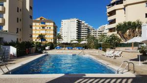 a swimming pool in the middle of some buildings at Sunny Beach in Benalmádena