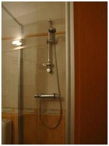 a shower in a bathroom with a shower head at Hotel South Charleroi Airport in Charleroi