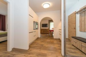 a hallway of a bedroom with a mirror at Appartements Herwig Schwarzenbacher in Weissensee