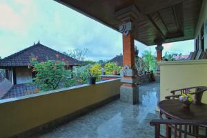 a balcony of a house with a view of a garden at Suwar Bungalows in Ubud