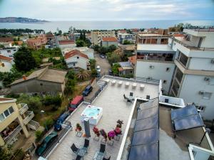 an aerial view of a city with a swimming pool on a building at Apartments Sarić in Bar