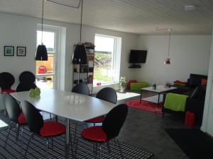 a living room with a table and chairs at Thorupgaard Farm Holiday in Stenum