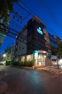 a building with a sign on the side of it at PAMAhouse Boutique Hostel in Bangkok