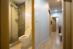 a bathroom with a toilet and a walk in shower at PAMAhouse Boutique Hostel in Bangkok +51 photos