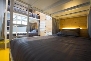 a bedroom with two bunk beds and a window at PAMAhouse Boutique Hostel in Bangkok