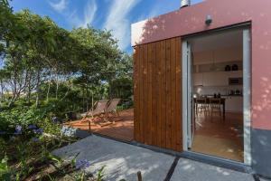 a small house with a deck and a patio at Quinta dos Peixes Falantes in Ribeira Grande