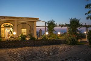 a house with a stone courtyard at night at Hotel Bellavista in Anacapri