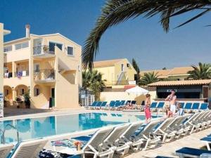 a swimming pool with lounge chairs and a house at Lemon Grove Hotels And Studios in Kavos