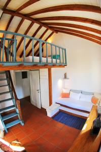 a living room with a couch and a staircase at Domus Nostos in Apolpaina