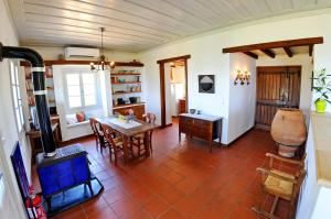 a living room with a table and a desk at Domus Nostos in Apolpaina +28 photos