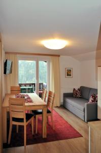 a living room with a table and chairs and a couch at Feichterhof in Bad Kleinkirchheim