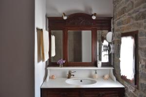 a bathroom with a sink and a mirror at Kolymbithres Seaside Villa in Kolympithres