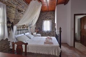 a bedroom with a bed and a brick wall at Kolymbithres Seaside Villa in Kolympithres