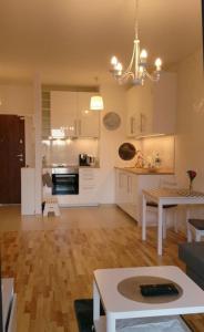 a living room with a kitchen and a dining room at 1 Bedroom Francuska Park Apartment in Katowice