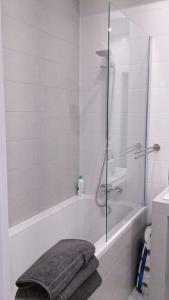 a bathroom with a shower and a bath tub with towels at 1 Bedroom Francuska Park Apartment in Katowice