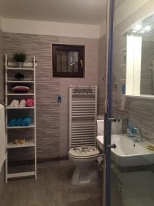 łazienka z toaletą i umywalką w obiekcie Apartman Cvenkica w mieście Omišalj