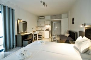 a room with a bed and a kitchen and a living room at Balito in Kato Galatas +43 photos