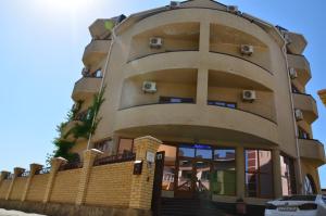 a building with a fence in front of it at Hotel Venetsia in Sukko