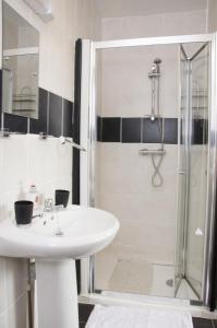 a bathroom with a sink and a shower at Pretoria Guest House in Bridlington