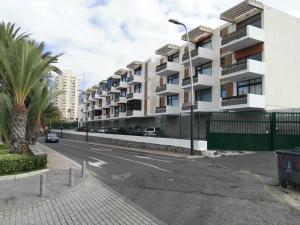 an empty street in a city with buildings at Americas Heart ! in Arona