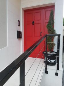 a red door on a house with a plant in a pot at Apartments Elda in Makarska