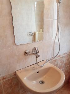 a sink in a bathroom with a shower at Guest Rooms Denitsa in Obzor +13 photos