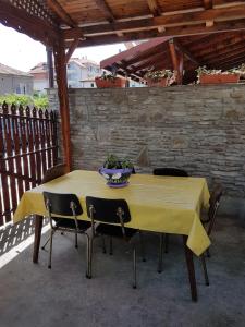 a yellow table with chairs and a bowl on it at Guest Rooms Denitsa in Obzor