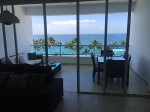 a living room with a view of the ocean at Marbella Juan Dolio in Juan Dolio