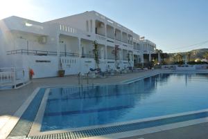 a hotel with a swimming pool in front of a building at Kokalakis Hotel in Kefalos