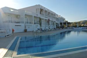 a hotel with a swimming pool in front of a building at Kokalakis Hotel in Kefalos