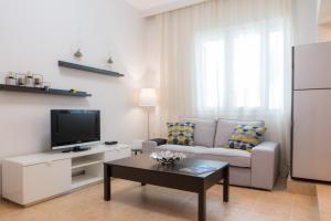 a living room with a couch and a tv at Casa Afrodite in Corfu